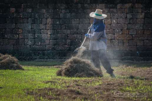 A local worker keeps Sukhothai looking beautiful for all the tourists