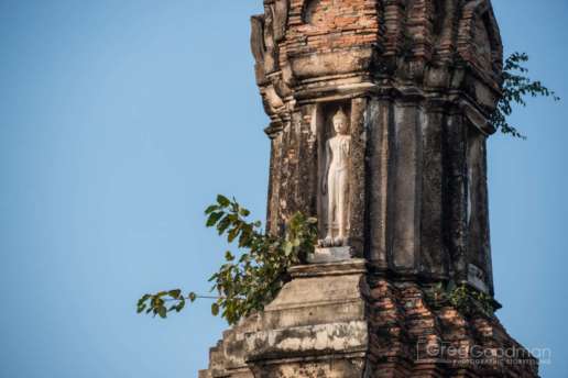 Crane your neck and look up - Buddha statues are hidden everywhere - like this one atop Wat Traphang Ngoen
