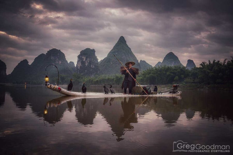 Photographing a cormorant fisherman preps for the day in Yangshou, Guangxi, China