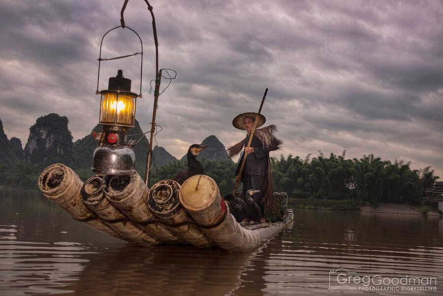 Photographing a cormorant fisherman preps for the day in Yangshou, Guangxi, China